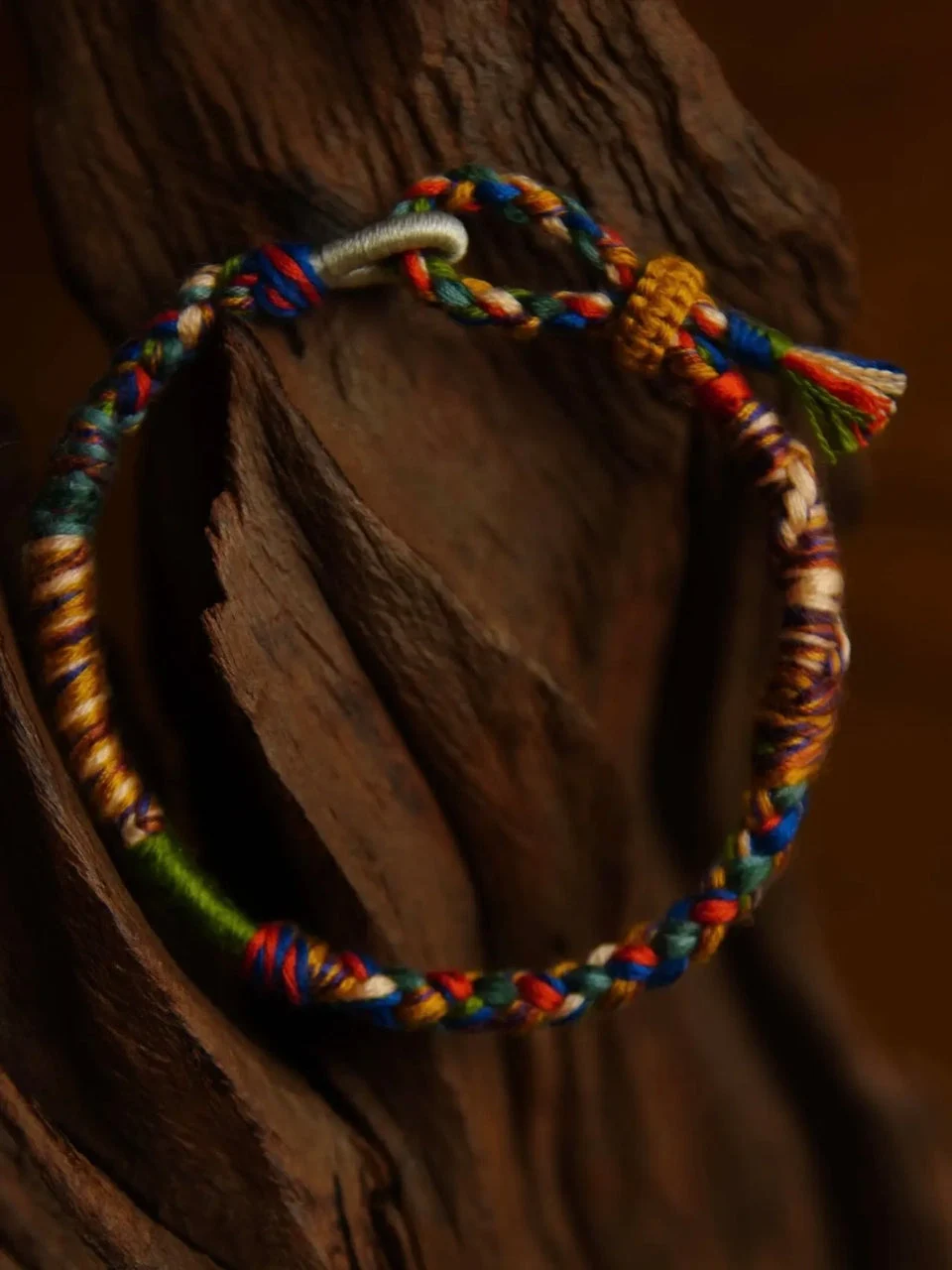 Colorful braided bracelet on a wooden surface